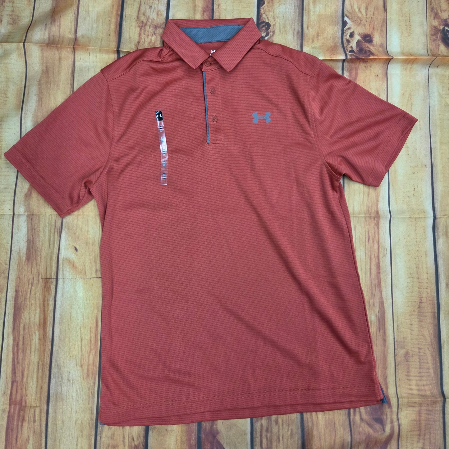 UA MENS TECH BRICK RED POLO 1290140-636